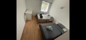 a small living room with a couch and a window at nature et confort in Vaugneray