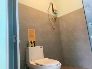 a bathroom with a toilet and a shower at Midori Heritage Coffee Farm in Da Lat +219 photos