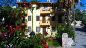a building with flowers in front of it at Flower Hotel Patara in Patara