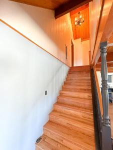 a staircase in a house with wood floors and a ceiling at On Golf Course, Family&Pet Friendly Yosemite Basecamp in Groveland +52 photos