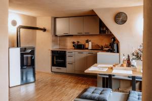 a kitchen with stainless steel appliances and a table at Schmuckers Ferienstube in Michelstadt