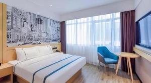 Łóżko lub łóżka w pokoju w obiekcie City Comfort Inn Wuhan Huangpu
