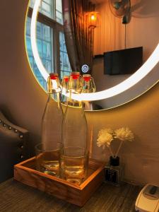 a tray with four wine glasses and a mirror at H2T Hotel Center BuiVien in Ho Chi Minh City +25 photos
