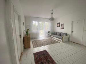 a living room with a couch and a window at Lillybeth Lakeside in Keszthely