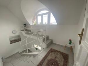 a white staircase with a round window in a room at Lillybeth Lakeside in Keszthely +54 photos