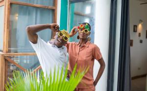 a man and a woman wearing a crown and sunglasses at Pili Pili Tropical Island in Jambiani