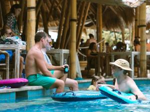 a group of people sitting in the swimming pool at Hai Tide Beach Resort in Nusa Lembongan