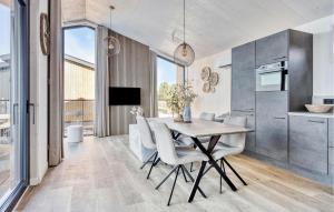 a kitchen and dining room with a table and chairs at Awesome Home In Kerkdriel With Wifi in Kerkdriel