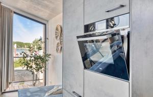 a kitchen with an oven with a view of the water at Awesome Home In Kerkdriel With Wifi in Kerkdriel