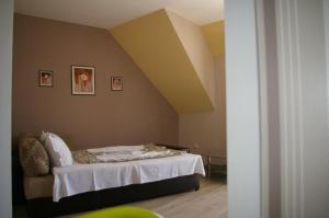 a bedroom with a bed with a white blanket at Sea View Apartments in Sozopol