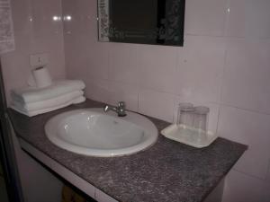 a white sink in a bathroom with a counter at Sisavath Hotel in Ban Houadông +155 photos