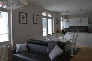 uma sala de estar com um sofá, uma mesa e uma cozinha em Caboteurs em Le Pouliguen