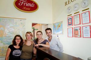 a group of people standing at a counter at Friends Hostel in Bucharest