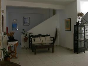 a living room with a couch and a staircase at Eri Hotel in Parikia