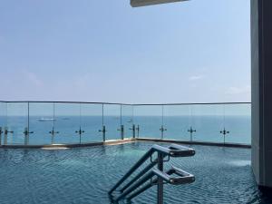 a swimming pool with a view of the ocean at Luxury 1 Bed in Trilogy, Limassol Seafront in Limassol
