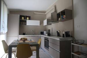 a small kitchen with a table and a table and chairs at A Casa di Lilly in Albenga