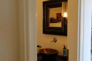 a bathroom with a wooden sink and a mirror at Aqua Dream Villa in Vourkari