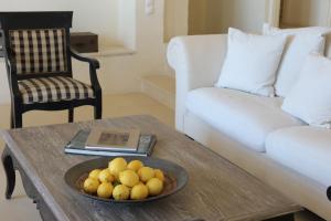 a bowl of fruit on a coffee table in a living room at Aqua Dream Villa in Vourkari +23 photos