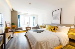 a bedroom with a large white bed with yellow pillows at Bi'an Time Hotel -Chongqing Guanyin Bridge Branch in Chongqing