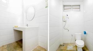 a white bathroom with a toilet and a sink at OYO 75351 Na Jinthanakan in Ban Tha Lo +36 photos