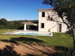 a house with a swimming pool in front of it at Villa Florida 2 with private pool in San Teodoro