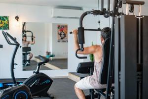 a man working out in a gym at Hotel Port 7- Boutique Collection in Agios Nikolaos