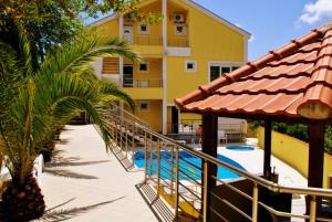 a resort with a staircase leading to a swimming pool at Crypto Hills Montenegro in Herceg-Novi