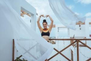 a woman in a bikini making a heart sign on a boat at Pili Pili Tropical Island in Jambiani