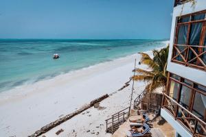 a view of the beach from the balcony of a building at Pili Pili Tropical Island in Jambiani