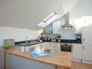 a kitchen with a table with a tea pot on it at The Hayloft - Uk36516 in Germoe +10 photos