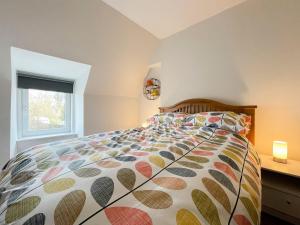 a bedroom with a bed and a window at Academy Street Cottage in Tain +4 photos