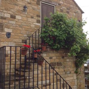 a brick wall with stairs leading up to a balcony at Hops and the Vines in Shipston on Stour