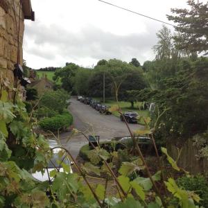 a street with cars parked in a parking lot at Hops and the Vines in Shipston on Stour