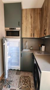 a small kitchen with a refrigerator and a dishwasher at Apartman CA34 in Villajoyosa +9 photos