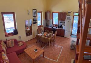 a living room with a couch and a table at Kroni vendégház in Tiszanána