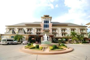 a hotel with a fountain in front of a building at Sabai Hotel Korat in Ban Khok Phai (1)