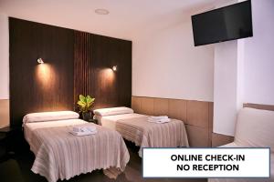 Postel nebo postele na pokoji v ubytování V Pension & Suites