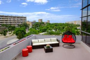 a balcony with a couch and a chair on a building at ZhanaOtel Hotel in Aktau