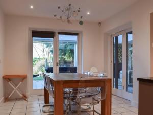 a dining room with a wooden table and chairs at Redwood House in Hoby