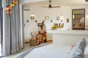 a man and a woman sitting in a room at Pili Pili Tropical Island in Jambiani