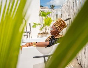 a woman sitting in a chair in a bath tub at Pili Pili Tropical Island in Jambiani