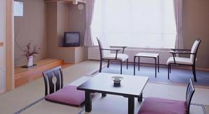 下高井郡にあるHotel North Shigaのリビングルーム(テーブル、椅子、テレビ付)