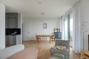 a living room with a couch and a table at Hoch hinaus - Pool am Dach, Rundum Balkon mit Traumaussicht in Vienna