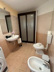 a bathroom with a toilet and a sink at La Claudette 2 in Catania +6 photos