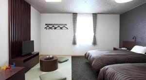 a bedroom with a bed and a television in it at Hotel Ligare Kasugano in Nara +159 photos