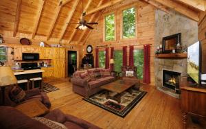 a living room with a couch and a fireplace at Chardonnay Getaway in Pigeon Forge