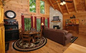 a living room with a couch and a table at Chardonnay Getaway in Pigeon Forge