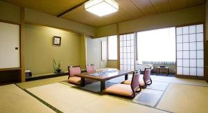 a dining room with a table and chairs in a room at Hotel Shofuen in Miya