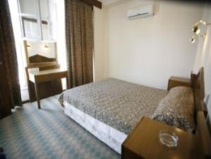 Ein Bett oder Betten in einem Zimmer der Unterkunft Antik Ridvan Hotel