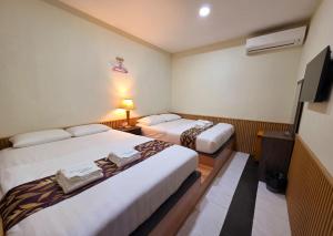 Ένα ή περισσότερα κρεβάτια σε δωμάτιο στο Grand Line Hotel Semporna